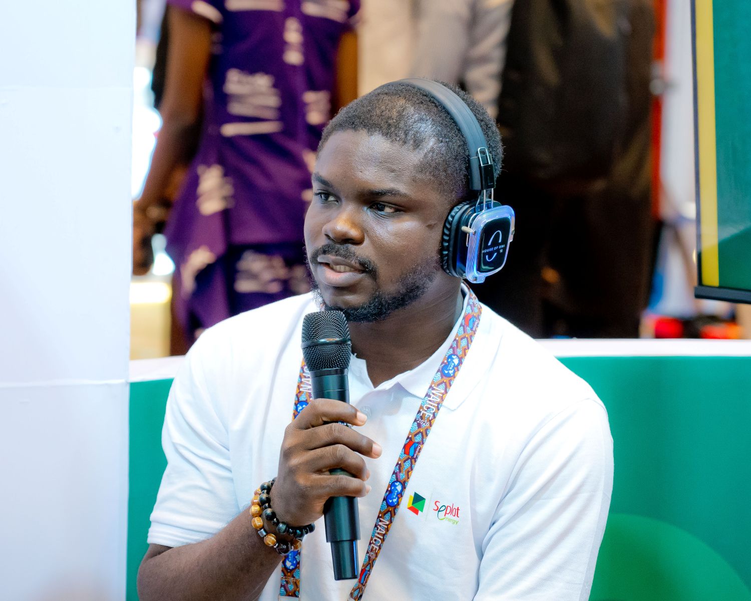 A SIGNALer speaking into a microphone at NAICE 2026.